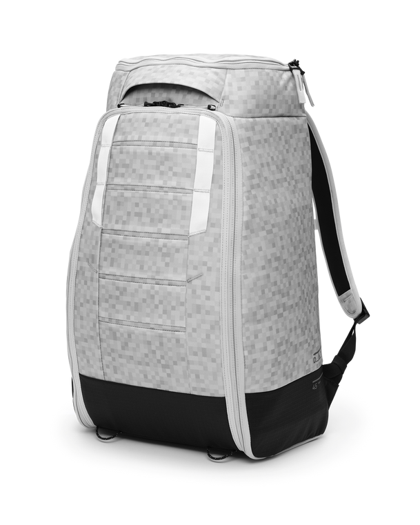 Db Hugger Bootpack 45L backpack in White Noise pixel pattern shown from a front three-quarter angle.